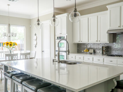 Modern luxury kitchen renovation in Perth with classic cabinets and a central island surrounded by leather barstools